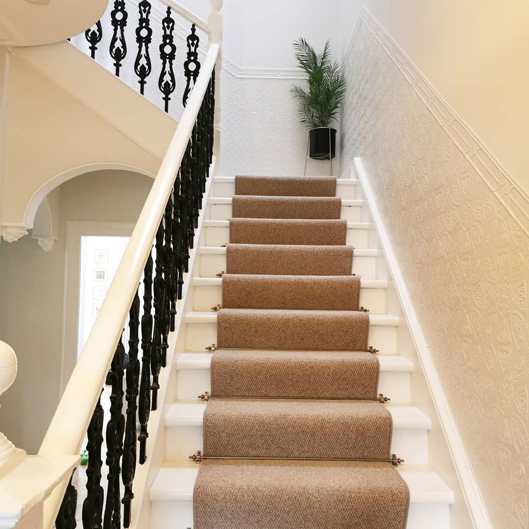 Striped carpet going up Victorian stairs